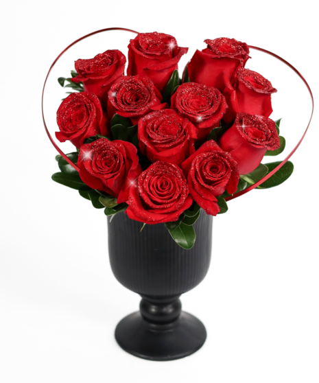 stunning glitter-kissed red roses set in a sleek black vase